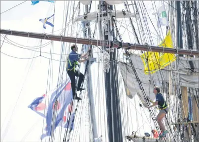  ?? CHRISTIAN ROACH/CAPE BRETON POST ?? Crew members can be seen climbing the mast of one of the Tall Ships docked in Louisbourg on Friday.