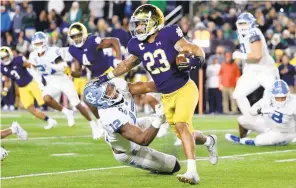  ?? GETTY ?? Notre Dame running back Kyren Williams stiff-arms North Carolina’s Tomon Fox on Saturday.