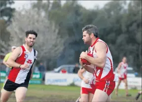  ??  ?? Snatch: Grant Hateley takes a strong grab for the Swans. Pictures: