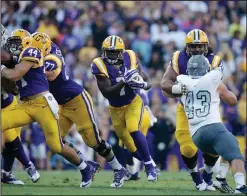  ?? AP PHOTO ?? In this Oct. 3, 2015, photo, LSU running back Leonard Fournette (7) carries past Eastern Michigan linebacker Anthony Zappone (43) in Baton Rouge, Louisiana.