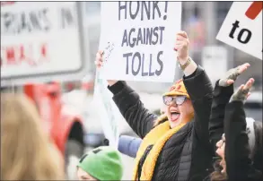  ?? Matthew Brown / Hearst Connecticu­t Media ?? Hilary Gunn, of Greenwich, seen here in February with approximat­ely 100 activists from the anti-toll group No Tolls CT, has been part of protests regularly taking place in Stamford to oppose tolls. Stamford has passed a non-binding resolution opposing tolls and Greenwich will consider a similar resolution before the RTM in April.