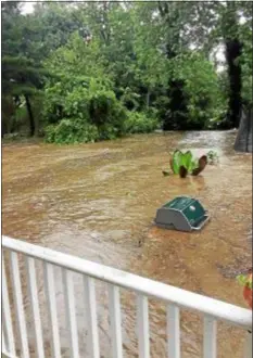  ?? SUBMITTED PHOTO ?? A yard of a home on Poplar Avenue is overwhelme­d by flood water following torrential downpours Monday.