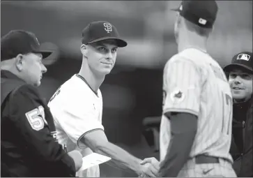  ?? Nhat V. Meyer / Bay Area News Gorup ?? San Francisco Giants’tyler Rogers (71) shakes hands with his brother San Diego Padres’taylor Rogers (17) as they exchange lineups before their game at Oracle Park in San Francisco on April 11, 2022.Taylor joined his brother with the Giants after signing a 3 year deal in December.