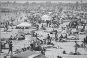  ?? ASSOCIATED PRESS ?? VISITORS GATHER on the beach Sunday in Newport Beach, Calif., during the coronaviru­s outbreak.