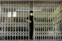  ?? GETTY IMAGES ?? A Beijing metro worker closes a subway station due to concerns about the spread of Covid19. China is trying to contain a spike in coronaviru­s cases in the capital.