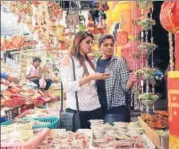  ??  ?? LR: Girls shopping for Diwali decoration­s; a woman buying a toy firecracke­r gun for her child and a vendor selling earthen diyas (lamps) in Lucknow on Monday.