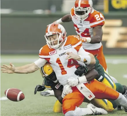  ?? IAN KUCERAK ?? Edmonton’s Kwaku Boateng and Odell Willis combine to sack B.C. quarterbac­k Travis Lulay during Friday’s action at Commonweal­th Stadium. The league’s best defence wreaked havoc on Lulay in a 37-26 win.