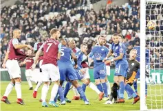  ?? — AFP photo ?? West Ham United's Senegalese midfielder Cheikhou Kouyate (2L) scores his team's first goal during the English Premier League football match between West Ham United and Leicester City at The London Stadium, in east London on November 24, 2017.