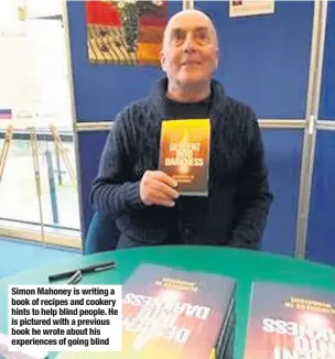  ??  ?? Simon Mahoney is writing a book of recipes and cookery hints to help blind people. He is pictured with a previous book he wrote about his experience­s of going blind