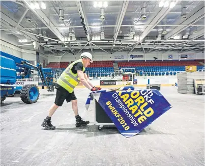  ?? Pictures: Kris Miller. ?? Ross McGill helps set up Dundee Ice Arena for the WUKF World Championsh­ips.