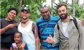  ??  ?? Jarred Thompson, second left, and his friend Thomas Brook, right, in a Fiji village before Thompson fell ill.