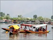  ??  ?? Tourists enjoy a shikara ride on Dal Lake, Srinagar.
