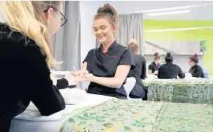  ??  ?? A student practises some beauty treatments