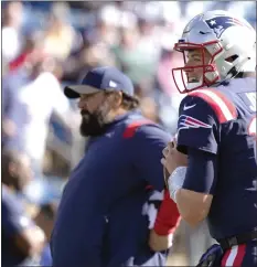  ?? AP FILE ?? Mac Jones steps back to throw as Matt Patricia looks on prior the Patriots game against the New York Jets on Oct. 24 of last year.