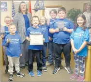  ?? Westside Eagle Observer/SUSAN HOLLAND ?? Seven members of the robotics club at Gravette Upper Elementary School display their robot, Bob, and awards they won at district competitio­n in Harrison during the February meeting of the Gravette school board. Pictured with their science teacher, Dorothy Hadley, are (from left) Gavin Puryear, Al Ruopp, Isaac Nichols, Jonah Shannon, Schuyler Lucht, Bobby Flippo and Ali Grotts. They will compete in state competitio­n at Arkansas Tech March 7.