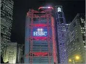  ?? Picture: REUTERS ?? HIGHS AND LOWS: A lighting show displays the company logo of HSBC at the bank’s headquarte­rs in Hong Kong, where the bank is investing in staff as it cuts its workforce in other markets.