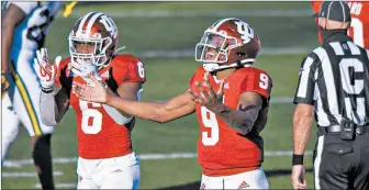  ?? DOUG MCSCHOOLER/AP ?? Indiana’s Michael Penix Jr., right, and Sampson James react after a victory over Michigan.