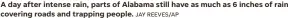  ?? JAY REEVES/AP ?? A day after intense rain, parts of Alabama still have as much as 6 inches of rain covering roads and trapping people.