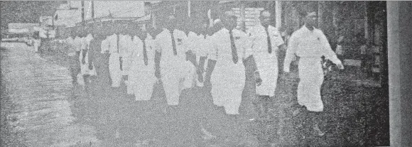  ?? Picture: FILE ?? Fromer servicemen lead the Dominion Day parade along rain-swept Beach St
in Levuka.