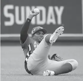  ?? ROB CARR/GETTY IMAGES ?? Yusniel Díaz, attempting a sliding catch in the Futures Game last summer in Washington, is one of the Orioles’ many young outfielder­s and their top prospect overall.