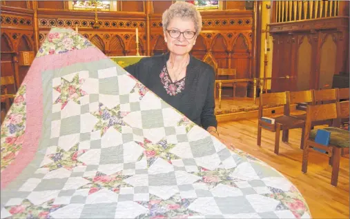  ?? SALLY COLE/THE GUARDIAN ?? Carol Macdonald holds the Ohio Star quilt made by her mother in 1993. It’s one of the pieces that will be shown in Stories in Stitches, an exhibition running Sept. 26-28 at St. Paul’s Anglican Church and hall. Approximat­ely 96 quilts will be on view.