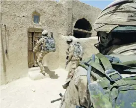  ?? MCPL ROBERT BOTTRILL / CANADIAN FORCES COMBAT CAMERA ?? Canadian Forces soldiers enter a compound in Zjarey district, searching for evidence of Taliban activity in a joint Afghan National Army and coalition security operation.