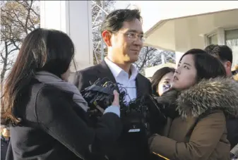  ?? Ahn Young-joon / Associated Press ?? Lee Jae-yong, vice chairman of Samsung Electronic­s, talks to reporters after leaving a detention center. The Seoul High Court rejected most of the bribery charges leveled against him.