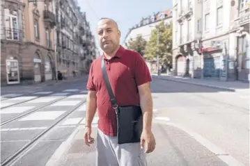  ?? JEAN-FRANCOIS BADIAS/AP ?? Afghanista­n’s Abdul Wali poses Sept. 4 in Strasbourg, France. Wali took the last bus out of a huge makeshift migrant camp in the northern French port of Calais. The bus took him to Strasbourg in the eastern part of the country.