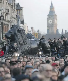  ?? ADRIAN DENNIS/AFP/GETTY IMAGES ?? People gather for a vigil in Trafalgar Square in central London in solidarity with the victims of the terror attack at the British Parliament and on Westminste­r Bridge.