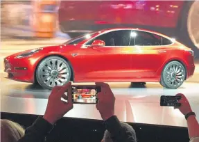  ?? Picture / AP ?? Shipment figures cast doubt over whether Elon Musk can ramp up production of the cheaper Model 3 sedan.