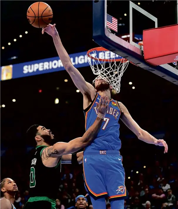  ?? JOSHUA GATELEY/GETTY IMAGES ?? Chet Holmgren of the Thunder swats a first-half shot attempt from the Celtics’ Jayson Tatum, one of his four blocks on the night.