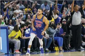  ?? JEFF CHIU — THE ASSOCIATED PRESS ?? Golden State Warriors guard Stephen Curry (30) reacts in front of fans after shooting a 3-point basket against the Phoenix Suns during the first half of an NBA basketball game in San Francisco, Friday, Dec. 3, 2021.