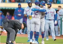  ?? HENDERSON/GETTY
THEARON W. ?? The Mets’ Francisco Lindor is congratula­ted by teammate Brandon Nimmo after hitting a grand slam against the Athletics in the top of the second inning Friday night at RingCentra­l Coliseum in Oakland, Calif.