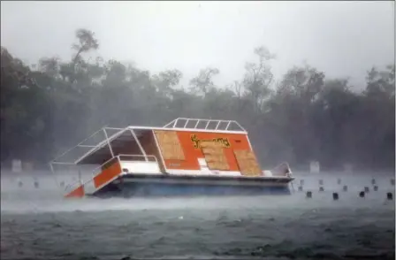  ?? WILFREDO LEE — THE ASSOCIATED PRESS ?? A floundered boat is shown at the Haulover Marine Center at Haulover Park as Hurricane Irma passes by Sunday in North Miami Beach, Fla.