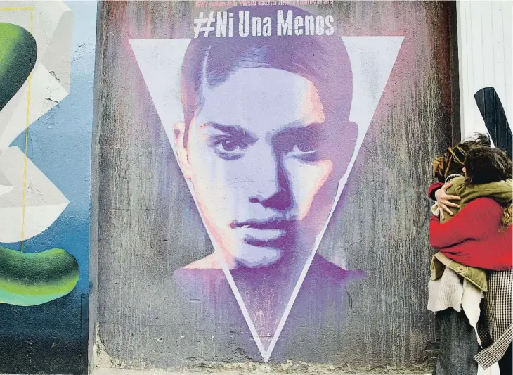  ?? ?? Dues dones davant d’un mural de denúncia de la violència masclista