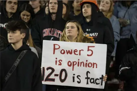  ?? Associated Press ?? A Cincinnati fan’s sign sums up the feelings of the Bearcats faithful: They belong.