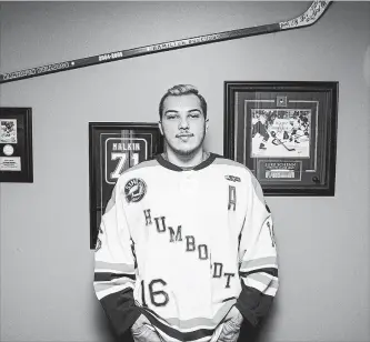  ?? KAYLE NEIS THE CANADIAN PRESS ?? With a stick from the 2004-2005 Hamilton Bulldogs on the wall behind him, Kaleb Dahlgren, one of the survivors of the deadly Humboldt Broncos bus crash stands for a portrait in his home in Saskatoon.