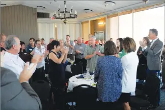  ??  ?? Following the announceme­nt of Yuba County’s 2017 Business Champion, The Country Florist owner Kevin DeHoff, center, receives a standing ovation from his peers during the seventh annual luncheon on Friday.