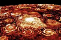  ??  ?? Two computerge­nerated images of Jupiter’s south (top) and north (bottom) polar regions, based on data captured by Juno’s Jovian Infrared Auroral Mapper (JIRAM) instrument. Note how both have a central cyclone surrounded by a number of smaller ones