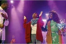  ?? PHOTO: WASHINGTON POST ?? Janqueshia Gay, 27, from Baltimore raises her hands while thanking pastor Stephen Chandler, left, and his wife, Zai Chandler, right, after she won a new car at Destiny Church in Columbia, Maryland.