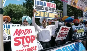  ?? Photo: AFP ?? Indian Sikh protesters display posters against Prime Minister Narendra Modi in front of the White House in Washington, DC, ahead of his meeting with US President Donald Trump yesterday.