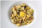  ??  ?? A black-pepper tagliatell­e is glazed with egg yolk and punctuated with pancetta.