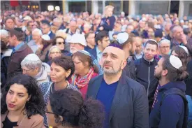  ?? MARKUS SCHREIBER/ASSOCIATED PRESS ?? People wear Jewish skullcaps during a demonstrat­ion against anti-Semitism in Berlin on Wednesday.