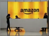  ?? MARK LENNIHAN — THE ASSOCIATED PRESS FILE ?? In this file photo, people stand in the lobby for Amazon offices in New York.