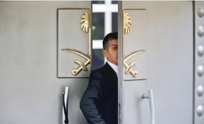  ?? LEFTERIS PITARAKIS/AP ?? A security guard walks into the Saudi Arabian consulate in Istanbul, Turkey, on Tuesday. U.S. resident Jamal Khashoggi, a critic of the Saudi government, went missing more than a week ago after entering the consulate.