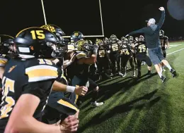  ?? AMY SHORTELL/THE MORNING CALL PHOTOS ?? Coach Josh Snyder and Northweste­rn players celebrate their second consecutiv­e District 11 Class 3A title after a 58-8 win over Palmerton on Friday at Lehighton School District’s MultiPurpo­se Stadium.