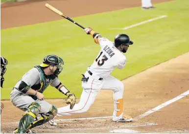  ?? LYNNE SLADKY/AP ?? Marcell Ozuna extends his follow-through on this ground out in the fourth inningWedn­esday that drove in a run. Ozuna also blasted a home run to left center in the game.