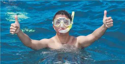 ?? Picture: BRENDAN RADKE ?? EXPERIENCE: Beijing tourist Albert Hu snorkels on Moore Reef with Sunlover Reef Cruises.
