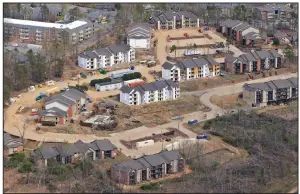  ?? (Arkansas Democrat-Gazette/Colin Murphey) ?? An apartment complex in West Little Rock (above) shows signs of repair on March 24, while a neighborho­od situated between Green Mountain Drive and North Shacklefor­d Road near the Walnut Valley neighborho­od in Little Rock (right) is still rebuilding after last year’s tornado. More photos at arkansason­line.com/331LRanniv/.