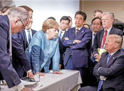  ?? Photo: Reuters ?? German Chancellor Angela Merkel speaks to US President Donald Trump during the second day of the G7 meeting in Charlevoix city of La Malbaie, Quebec, Canada on June 9, 2018.